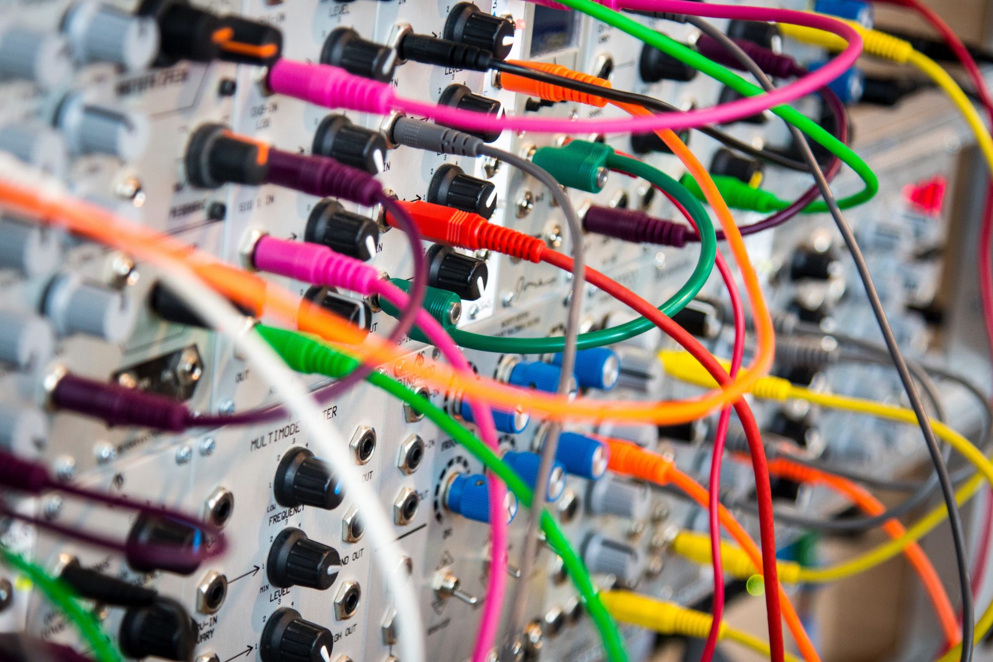 Close-up, shallow-focus photo of a switch board with colorful knobs and wires